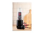 Black personal blender with berries and water, ready to blend, on a wooden counter.