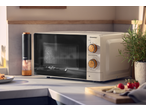 SILVERCREST® 700W Microwave with wooden dials on a kitchen counter with spices and herbs.