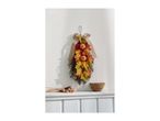 Autumnal wall hanging with pumpkins and leaves, a wooden bowl, and dried flowers on a white shelf.