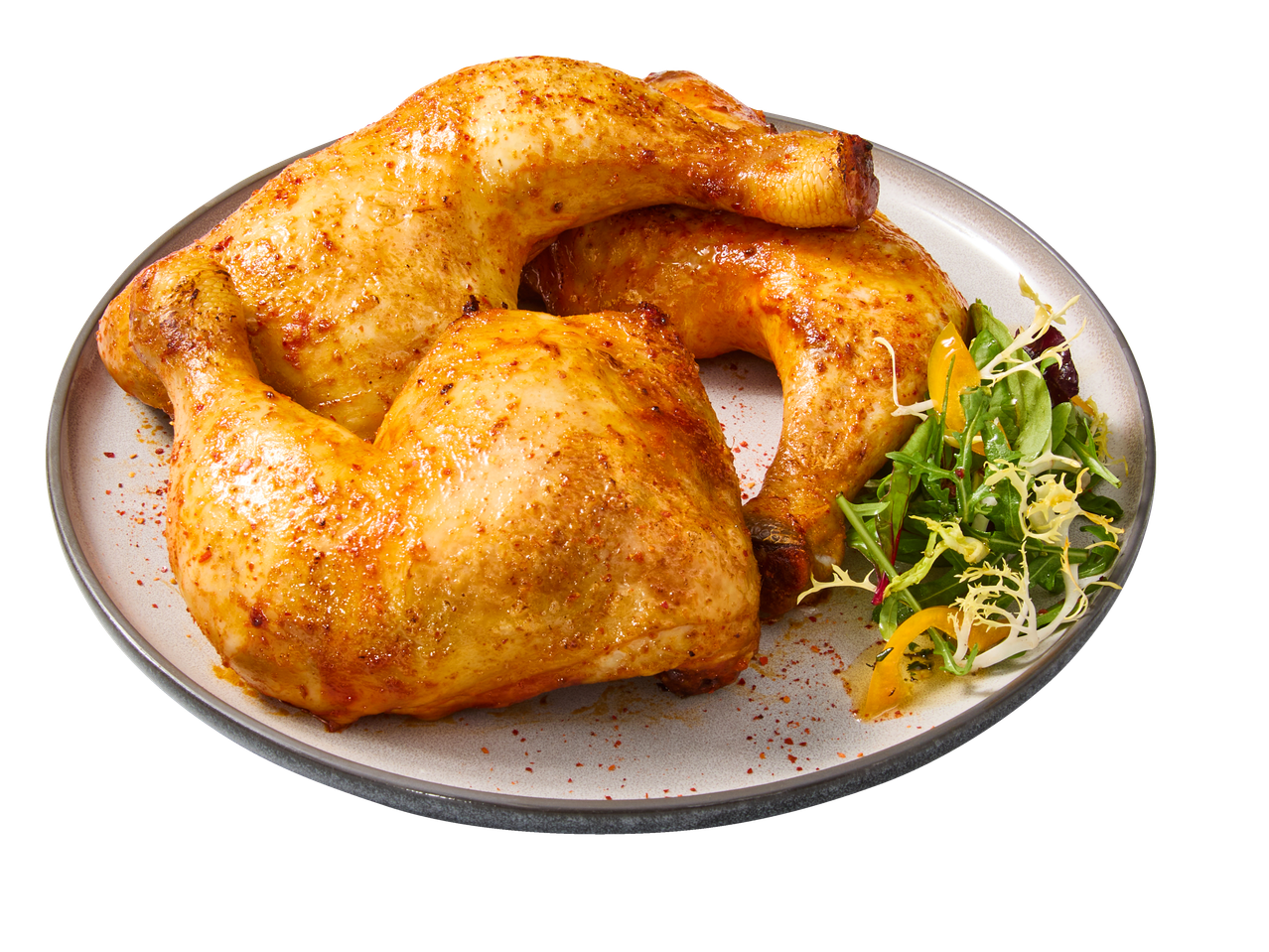 Pernas e coxas de frango assadas com salada num prato.