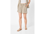 Woman wearing beige linen shorts, a white top, and a matching open shirt, with beige sandals.