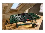 A comprehensive toolkit with various hand tools, including screwdrivers, pliers, a hammer, and a tape measure, on a wooden surface in an attic.