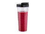Blender cup filled with red smoothie