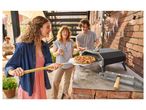 Outdoor pizza oven: friends enjoying a freshly baked pizza.