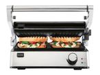 Stainless steel panini press with two Caprese sandwiches, open and ready to grill.