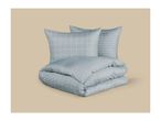 Light blue bedding set with a grid pattern, including two pillows and a folded duvet.