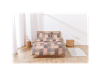 Patchwork-style bedding set on a bed in a bright bedroom.