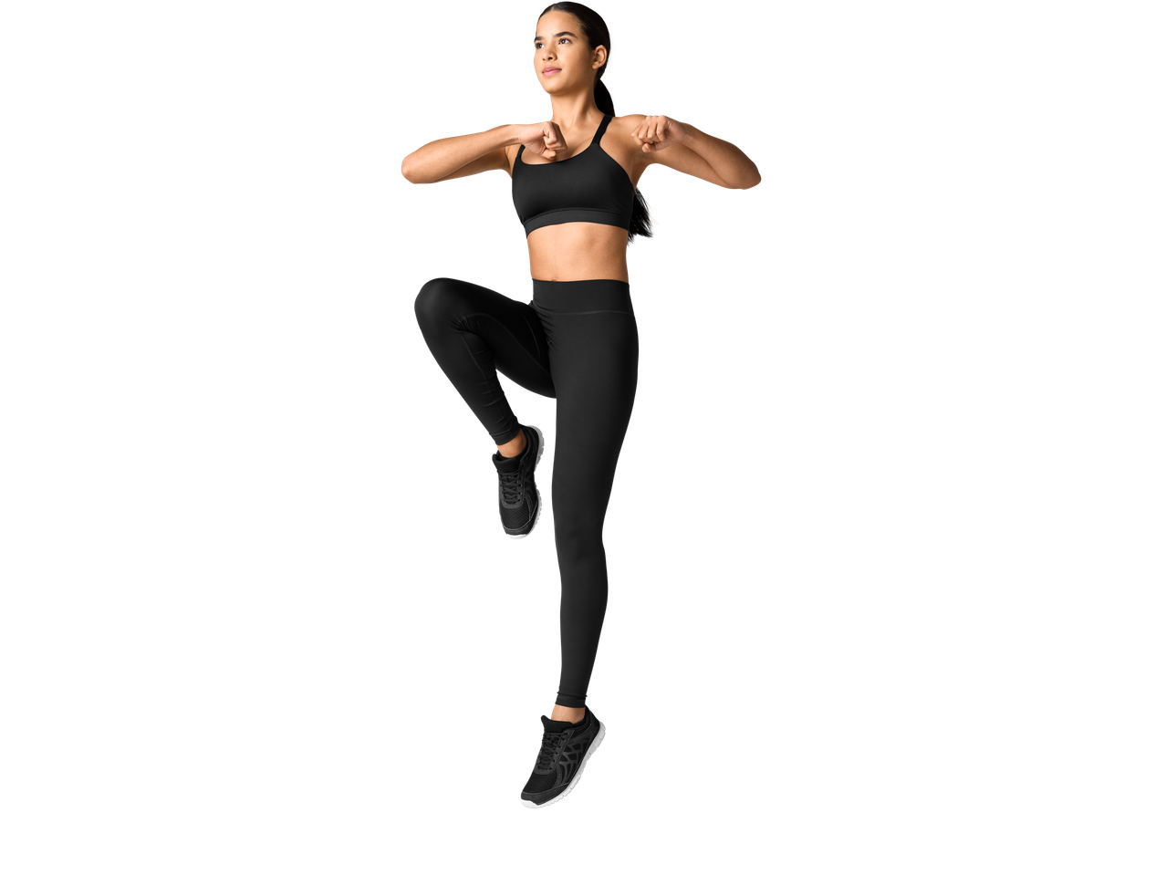 Mulher em leggings pretas e sutiã desportivo CRIVIT® a fazer exercício