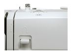 Close-up of a white sewing machine with a dial and thread.