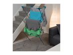 Clothes drying rack with various garments, including shirts and underwear, in a living room setting.