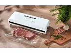 SILVERCREST® Vacuum Sealer with meat in a vacuum bag, herbs, and garlic on a wooden board.