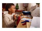 A child plays with a wooden camera and a drawing activity set on a wooden table.