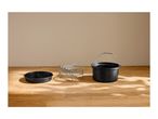 Air fryer accessories: a round baking pan, a metal rack with skewers, and a pot.