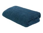 A dark teal bath towel folded on a white background.