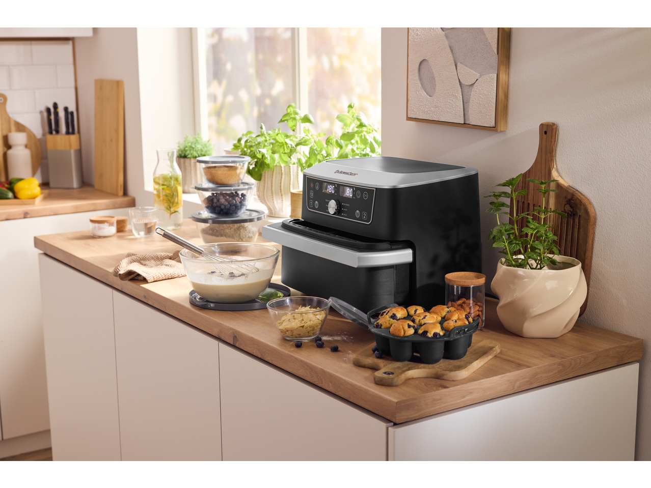 SILVERCREST® Glass Bowl Set in a kitchen with an air fryer and baking ingredients.