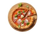 Pizza with ham, mozzarella, red onion, and basil on a wooden board, with one slice removed.