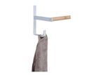 White metal towel rail with a wooden bar and a grey towel hanging from a hook.