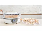 Séchoir alimentaire électrique avec plateau de fruits séchés.