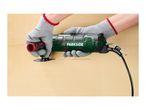 Hands in protective gloves using a multi-tool to cut a groove in a wooden surface.