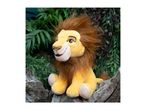 A plush Simba from Disney's The Lion King sits on a tree stump.