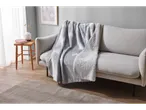LIVARNO home Blanket with white tree pattern draped over a light grey sofa in a living room