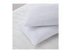 Two white pillows on a white mattress with quilted lines.