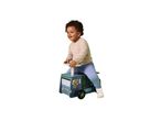 A happy toddler riding a blue wooden ride-on toy truck with a lion illustration.