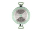 Bottom view of a light green cooking pot with two handles and a metallic base