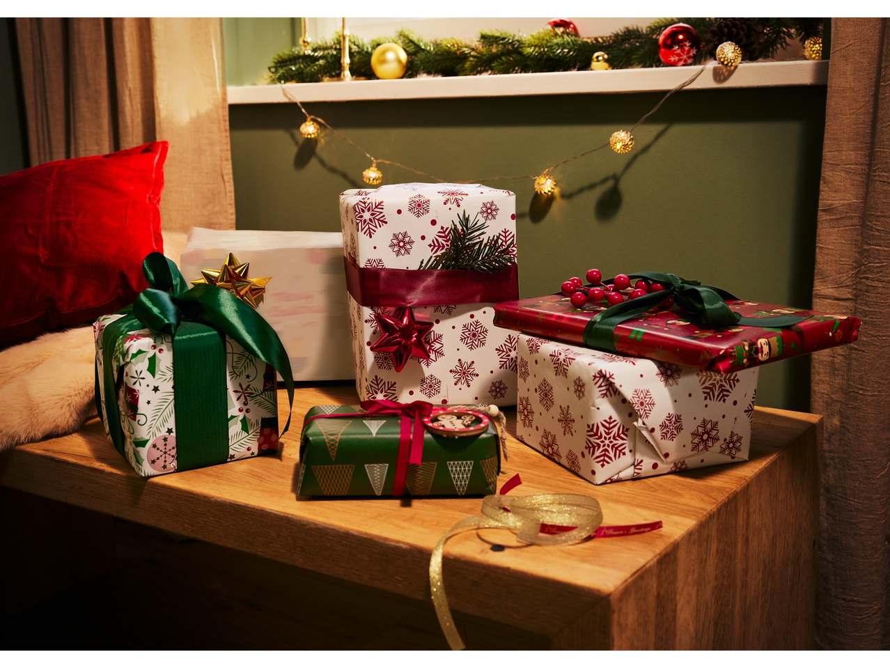 Crelando® wrapping paper in various festive designs with ribbons and decorations.