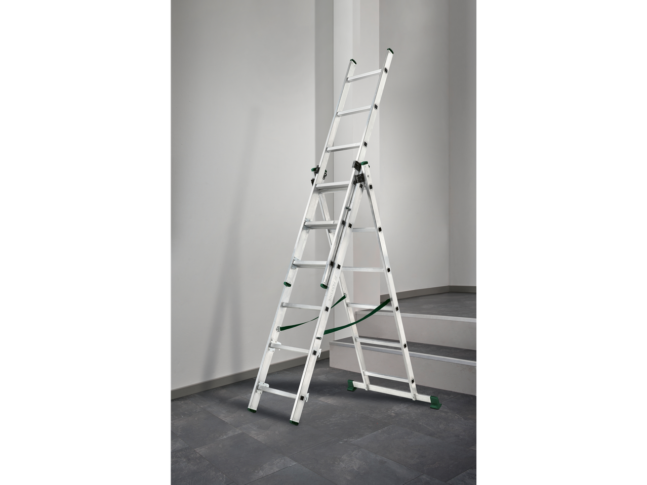 A silver PARKSIDE multi-purpose ladder stands on a dark tiled floor against a white wall.