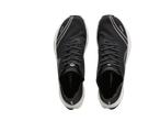 Crivit running shoes, black with white soles and reflective stripes, top view.