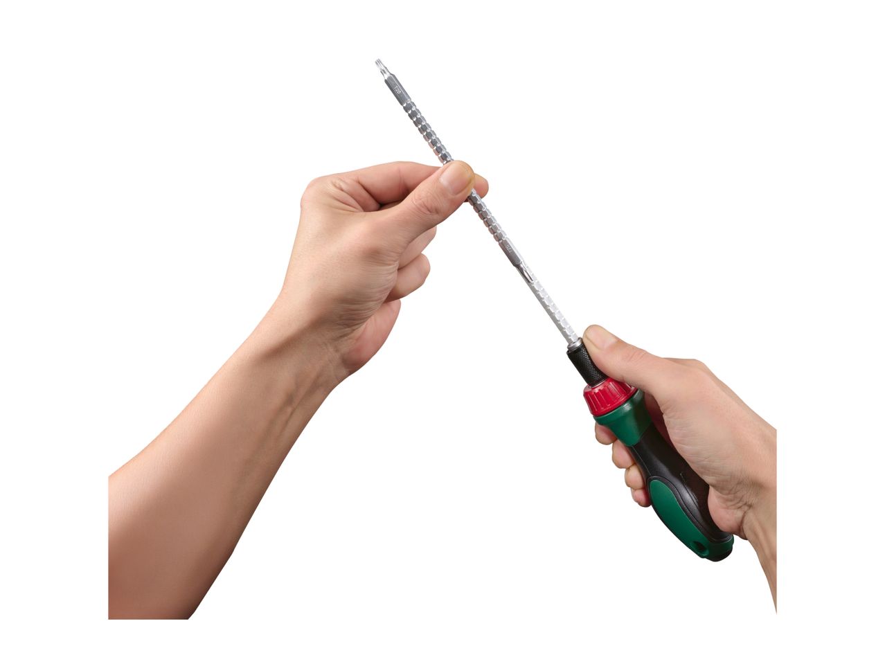 Hands holding a screwdriver with interchangeable bits.