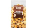 A clear bag of Second Street Bakeshop Gourmet Toffee Popcorn with a brown label.
