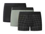 Three men's boxer briefs: one black, one light green, and one black with a green plaid pattern.