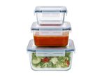 Stack of three glass food storage containers with blue lids, holding salad and soup.