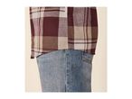 Close-up of a person wearing a plaid shirt and blue jeans.
