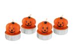 Four pumpkin-shaped tea light candles with carved faces