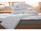 Pillows and duvet on a bed.