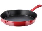 Red enameled cast iron pan with a black interior
