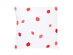White pillow with a scattered red strawberry pattern, some embroidered and some printed.