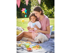 Mother and daughter enjoying a picnic with colorful plastic cutlery and bowls on a blanket.