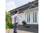 Woman using a Parkside® Extendable Pressure Washer Lance to clean a house roof.
