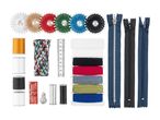 A collection of sewing supplies including thread, embroidery floss, needles, and zippers.