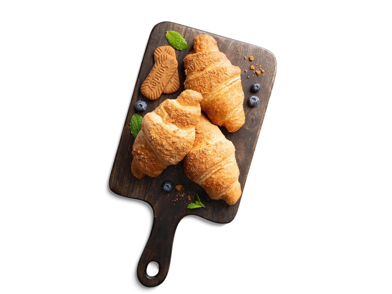 Croissant-ok, Sondey kekszek, áfonya és menta egy fa vágódeszkán.