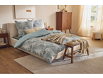 Bedroom with a bed featuring a light blue and green floral duvet cover, two side tables, and a wooden cabinet.