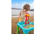 Child playing with a sand and water table on the beach