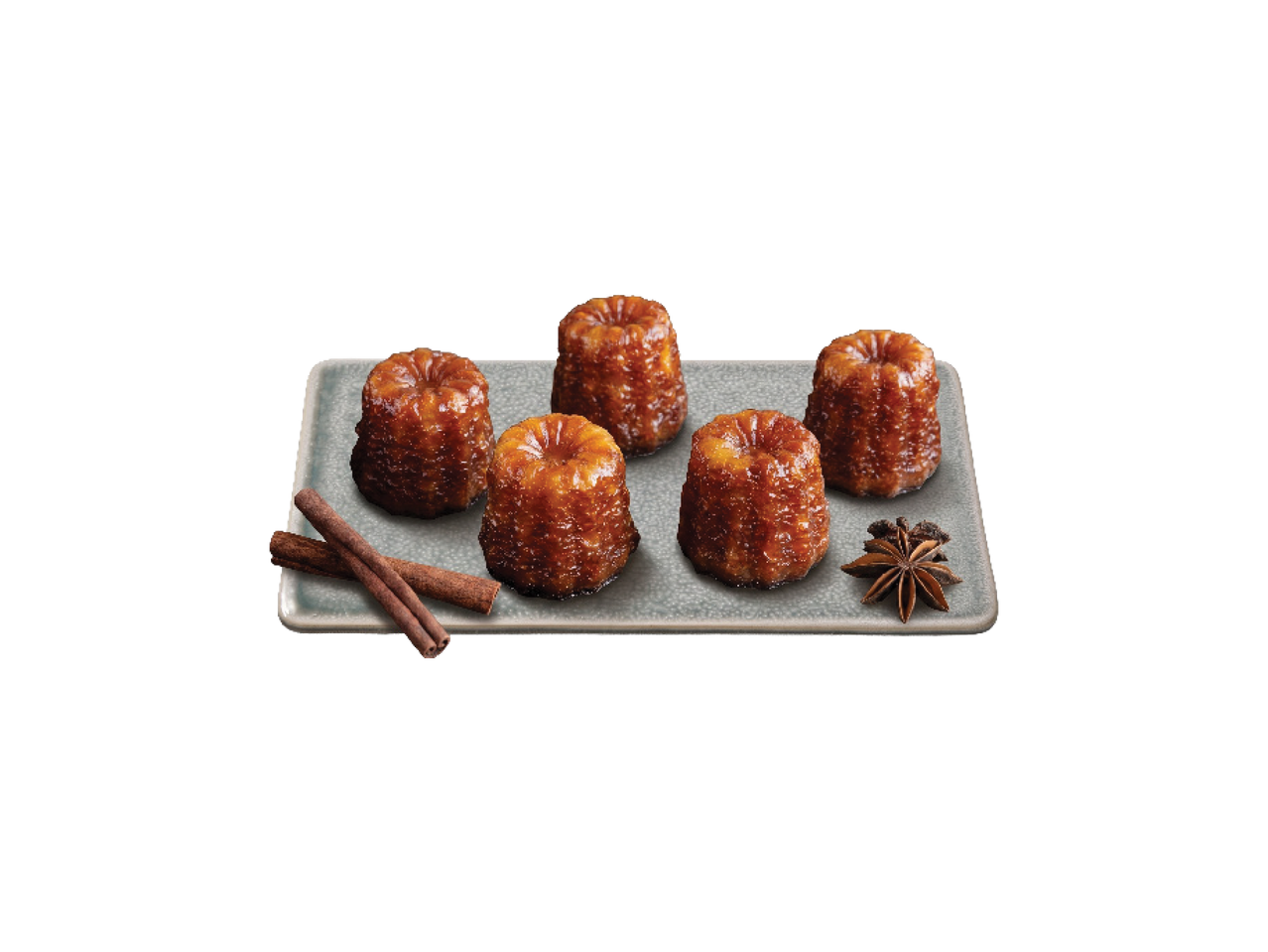 Viis kuldpruuni canelé kooki hallil kandikul koos kaneelipulkade ja tähtaniisiga.