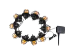 Solar-powered string lights with black lantern-style casings and warm yellow glow, arranged in a circle.