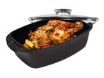 Roaster with glass lid containing a roasted chicken