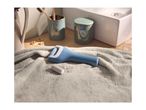 Blue electric foot file on a grey towel, with bathroom accessories in the background.